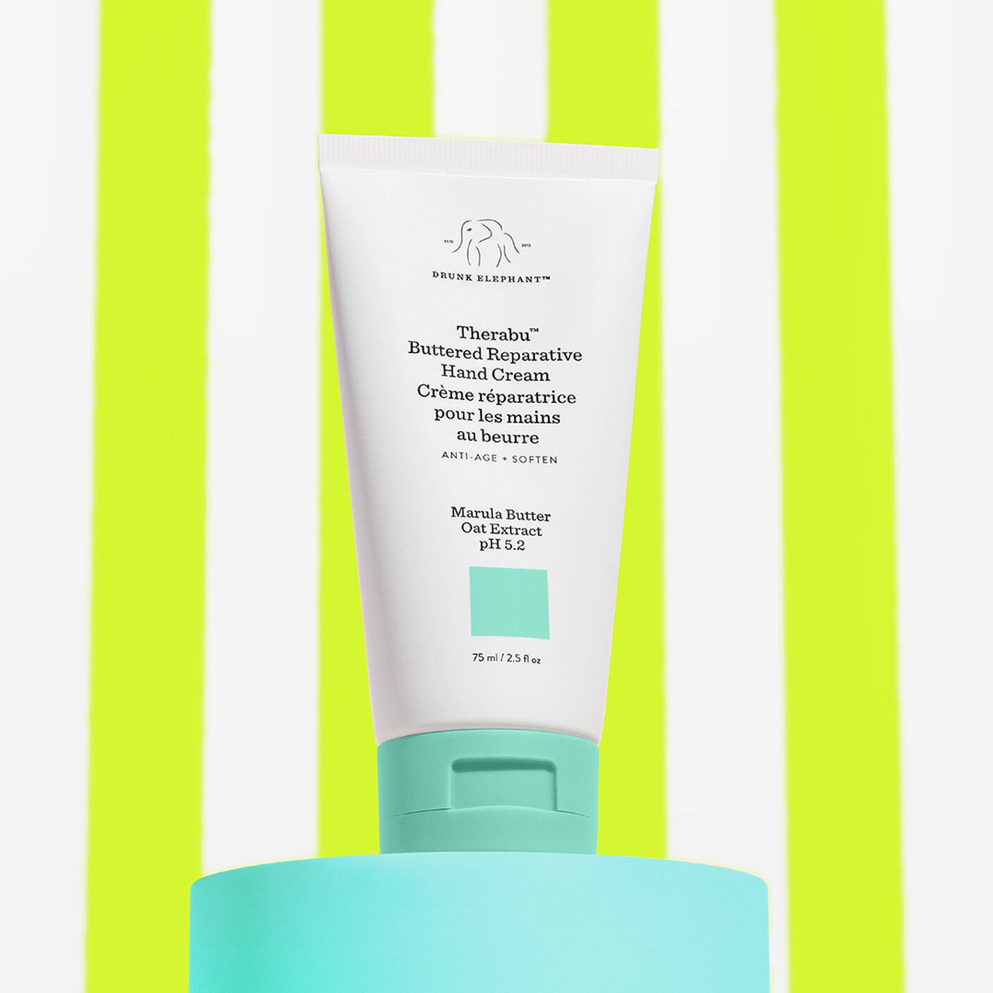 Therabu hand cream on a teal platform with a lime green and white striped background. 
